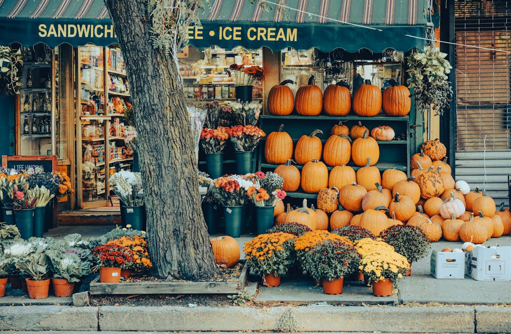 Charming street market in NYC with pumpkins and colorful flowers showcasing fall variety.