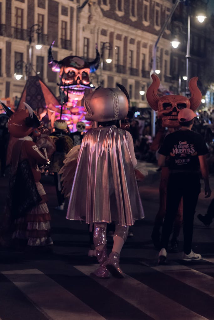 Vibrant costume parade with giant masks at night festival street event.