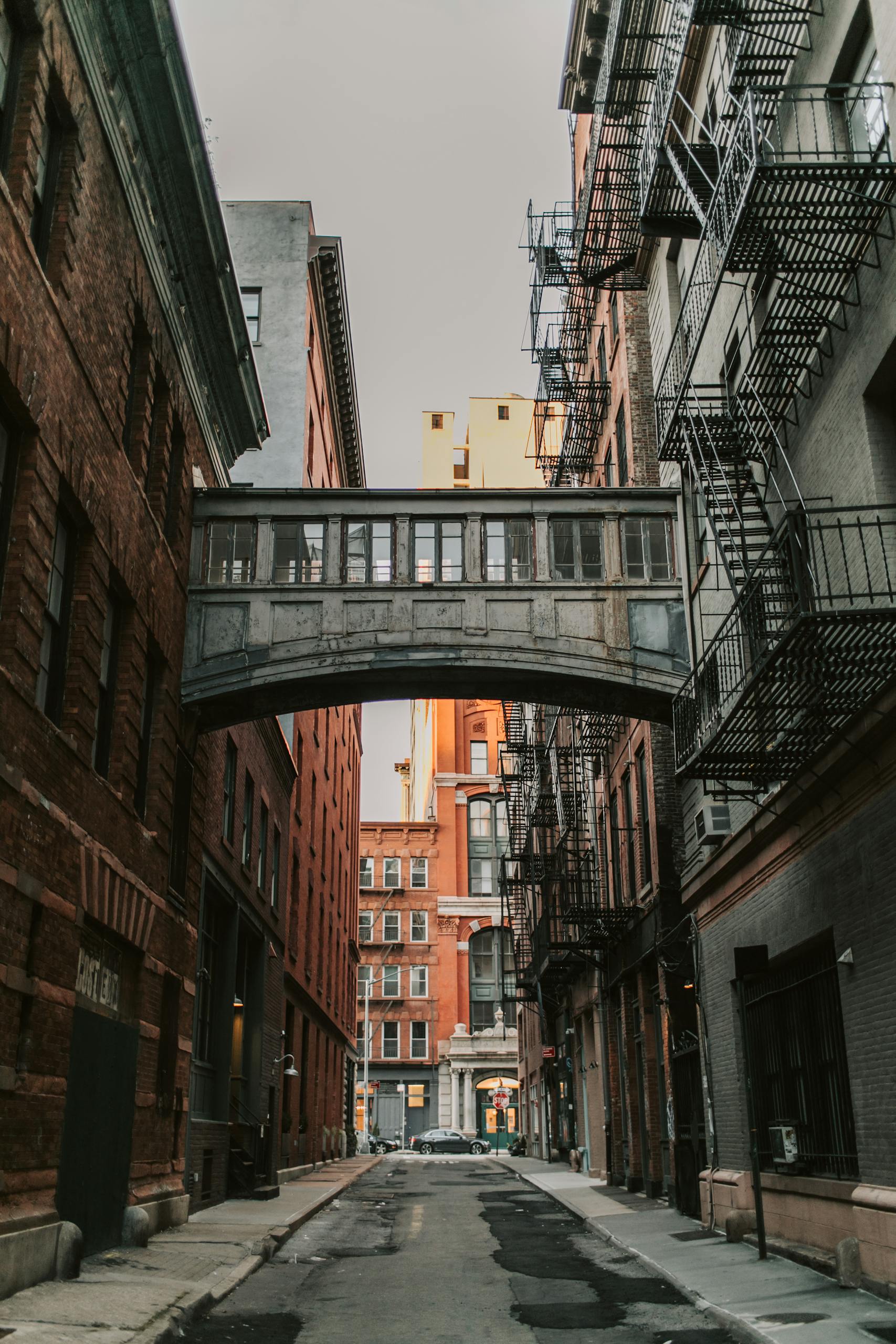 Explore the iconic Staple Street Skybridge connecting buildings in a New York City alleyway.