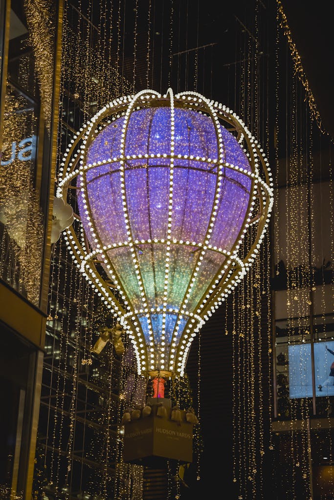 From below of balloon with glowing luminous Christmas lights hanging in tower in New York