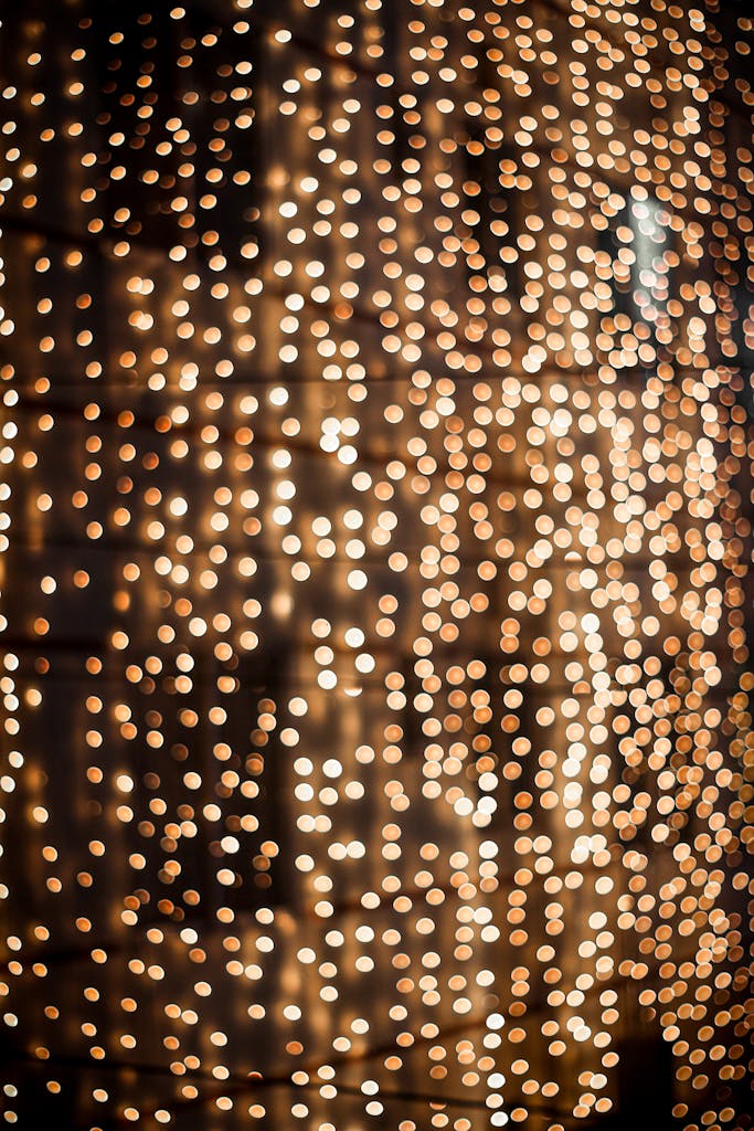 Glowing golden bokeh lights create a festive and abstract background.