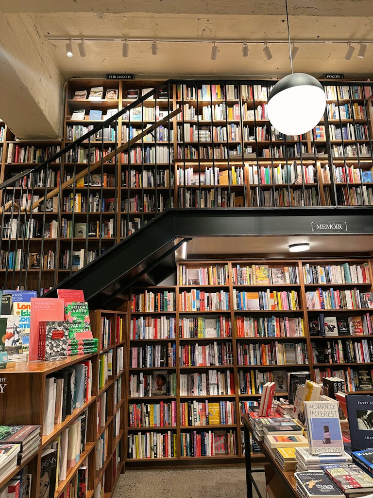 A quaint New York bookstore filled with shelves of books, offering a cozy reading environment.